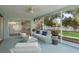 Relaxing screened porch with stylish decor and seamless access to the backyard at 1960 Canadiana Ct, Dunedin, FL 34698