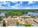 An aerial view of homes near a lake with landscaping and tree lined streets at 2119 Sugarbush Dr, Holiday, FL 34690