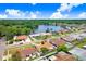 Aerial view of a residential neighborhood featuring homes, landscaping, and a lake at 2119 Sugarbush Dr, Holiday, FL 34690