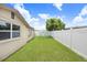 Lush green backyard featuring a climbing structure and a privacy fence at 2119 Sugarbush Dr, Holiday, FL 34690