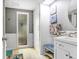 Bright bathroom features white wainscoting, decorative accents, glass shower door, and modern fixtures at 2119 Sugarbush Dr, Holiday, FL 34690