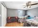 Spacious bedroom features two twin beds, a ceiling fan, and laminate flooring, perfect for a growing Gathering at 2119 Sugarbush Dr, Holiday, FL 34690