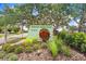 Forest Hills East neighborhood sign surrounded by lush greenery and landscaping at 2119 Sugarbush Dr, Holiday, FL 34690