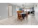 Open floor plan with dining table connecting living room and kitchen areas at 2119 Sugarbush Dr, Holiday, FL 34690
