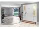 Spacious entryway featuring tile flooring, a decorative front door with sidelights, and plenty of natural light at 2119 Sugarbush Dr, Holiday, FL 34690