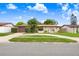 Charming single-story home with a two-car garage, mature landscaping, and a unique arched entryway at 2119 Sugarbush Dr, Holiday, FL 34690