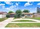Charming single-story home featuring a circular driveway, arched entryway, and well-maintained landscaping at 2119 Sugarbush Dr, Holiday, FL 34690