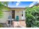 Charming front patio featuring mosaic tile, comfortable seating, and a welcoming entrance at 2119 Sugarbush Dr, Holiday, FL 34690