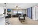 Bright living room adjacent to the kitchen with breakfast bar seating at 2119 Sugarbush Dr, Holiday, FL 34690