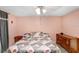 Comfortable main bedroom featuring a ceiling fan, wooden dresser, side table and decorative bedding at 2119 Sugarbush Dr, Holiday, FL 34690