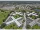 Expansive aerial view of a multi-building complex with lush green spaces and ample parking at 2466 Ecuadorian Way # 32, Clearwater, FL 33763