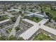 Aerial view featuring a well-maintained condominium community with mature trees and inviting green spaces throughout at 2466 Ecuadorian Way # 32, Clearwater, FL 33763