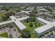 Aerial view showcasing a meticulously landscaped condominium community with manicured grounds and well-spaced buildings at 2466 Ecuadorian Way # 32, Clearwater, FL 33763