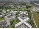Community aerial featuring spacious grounds, mature trees, and well-maintained buildings and parking at 2466 Ecuadorian Way # 32, Clearwater, FL 33763