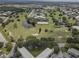 Scenic aerial view of the property showcases lush green spaces, mature trees and pond at 2466 Ecuadorian Way # 32, Clearwater, FL 33763