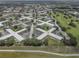 Aerial view of buildings and lush greenery of the neighborhood at 2466 Ecuadorian Way # 32, Clearwater, FL 33763