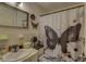 Bathroom with a sink, butterfly decor, and a shower curtain featuring a butterfly design at 2466 Ecuadorian Way # 32, Clearwater, FL 33763