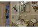 Small bathroom features a sink and vanity with decorative wall hangings and white tiled walls at 2466 Ecuadorian Way # 32, Clearwater, FL 33763