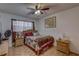 Bedroom with a bed, ceiling fan, parquet floors, and bedside tables, creating a comfortable and inviting space at 2466 Ecuadorian Way # 32, Clearwater, FL 33763