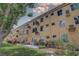 Exterior view of a multi-unit apartment building, showcasing its backyard and individual AC units at 2466 Ecuadorian Way # 32, Clearwater, FL 33763