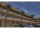 Exterior of a multi-story apartment building with decorative railings and palm trees, offering a tropical ambiance at 2466 Ecuadorian Way # 32, Clearwater, FL 33763