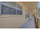 Hallway outside condo, which is shaded, carpeted, and leads to the unit door at 2466 Ecuadorian Way # 32, Clearwater, FL 33763