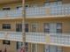 Beige condo building exterior with white lattice balcony and multiple units, perfect for comfortable living at 2466 Ecuadorian Way # 32, Clearwater, FL 33763