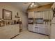 An efficiency kitchen with white appliances, beige tile floor, and dark mosaic backsplash at 2466 Ecuadorian Way # 32, Clearwater, FL 33763