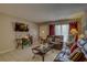 Comfortable living room with neutral paint, tile floors and leather furniture at 2466 Ecuadorian Way # 32, Clearwater, FL 33763