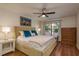 Inviting bedroom with a plush bed, a ceiling fan, and a large window providing natural light at 247 Los Prados Dr # 1123, Safety Harbor, FL 34695