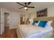 Bedroom features hardwood floors, a ceiling fan, and en-suite bathroom access at 247 Los Prados Dr # 1123, Safety Harbor, FL 34695