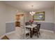 Dining room with tile floors, a marble-top table, and a view of the adjacent kitchen at 247 Los Prados Dr # 1123, Safety Harbor, FL 34695