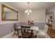 Cozy dining room features a marble table with chair seating beneath a charming chandelier at 247 Los Prados Dr # 1123, Safety Harbor, FL 34695