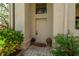 Front door area features plants, a welcome mat, and brick flooring, offering a warm entrance at 247 Los Prados Dr # 1123, Safety Harbor, FL 34695