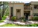 Inviting home exterior with a landscaped front yard, brick pathway, and charming facade at 247 Los Prados Dr # 1123, Safety Harbor, FL 34695
