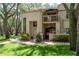 Charming townhouse featuring a private balcony, manicured lawn and brick-paved walkway to the front door at 247 Los Prados Dr # 1123, Safety Harbor, FL 34695