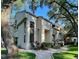 Inviting exterior elevation with lush landscaping, a brick walkway, and a charming architectural design at 247 Los Prados Dr # 1123, Safety Harbor, FL 34695