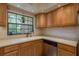 Charming kitchen featuring wood cabinets and a bright window that offers an outdoor view at 247 Los Prados Dr # 1123, Safety Harbor, FL 34695