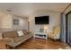 Cozy living room with hardwood floors, comfortable seating, and a mounted TV at 247 Los Prados Dr # 1123, Safety Harbor, FL 34695