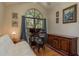 Office features a large window, desk, chair, futon and hardwood floors at 247 Los Prados Dr # 1123, Safety Harbor, FL 34695