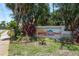 Community sign at Los Prados entrance with beautiful flowers and landscaping at 247 Los Prados Dr # 1123, Safety Harbor, FL 34695