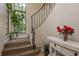 Elegant staircase featuring a large window, rod iron railing and carpeted steps at 247 Los Prados Dr # 1123, Safety Harbor, FL 34695