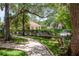 Picturesque community walkway surrounded by lush landscaping and mature trees at 247 Los Prados Dr # 1123, Safety Harbor, FL 34695