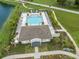 Aerial view of the Volanti community pool, amenities, and a walking path near the pond at 26082 Woven Wicker Bnd, Lutz, FL 33559
