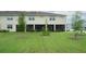 A lush, green backyard with a screened-in patio offers a private outdoor living space at 26082 Woven Wicker Bnd, Lutz, FL 33559