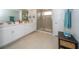 Large bathroom with double sink vanity, glass enclosed shower, and white cabinets at 26082 Woven Wicker Bnd, Lutz, FL 33559