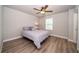 Bright bedroom featuring a ceiling fan, window, and neutral walls that provide a relaxing atmosphere at 26082 Woven Wicker Bnd, Lutz, FL 33559
