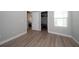 Open view of bedroom featuring wood look floors and closet space at 26082 Woven Wicker Bnd, Lutz, FL 33559