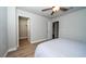 Secondary bedroom features a ceiling fan, ample closet space, and wood-look flooring at 26082 Woven Wicker Bnd, Lutz, FL 33559