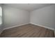 Empty bedroom showcasing wood-look flooring and neutral walls, ready for personal customization at 26082 Woven Wicker Bnd, Lutz, FL 33559